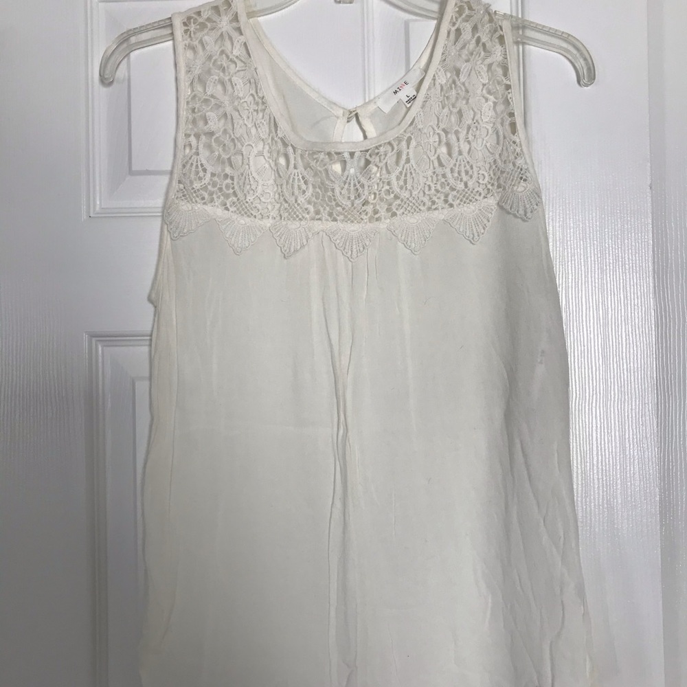 White flowy tank top with lace detail on the top